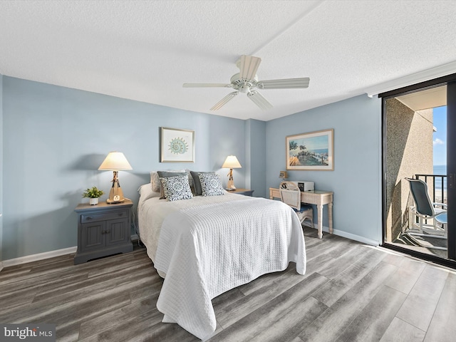 bedroom featuring ceiling fan, dark hardwood / wood-style floors, access to exterior, and a textured ceiling