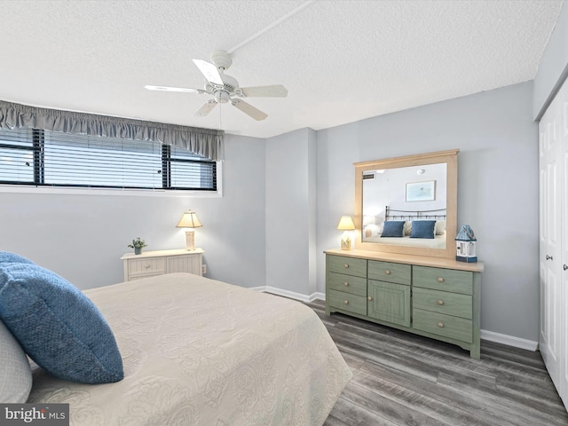 bedroom featuring ceiling fan, dark hardwood / wood-style floors, a textured ceiling, and a closet