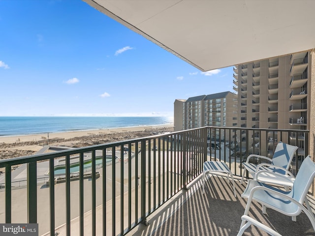 balcony with a beach view and a water view