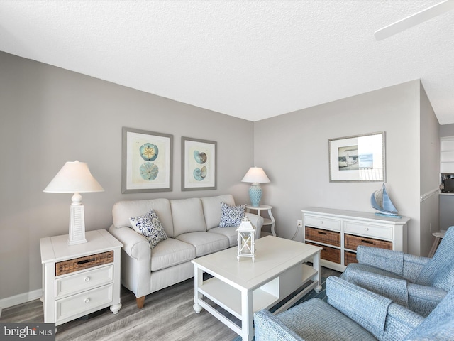 living room with hardwood / wood-style flooring and a textured ceiling