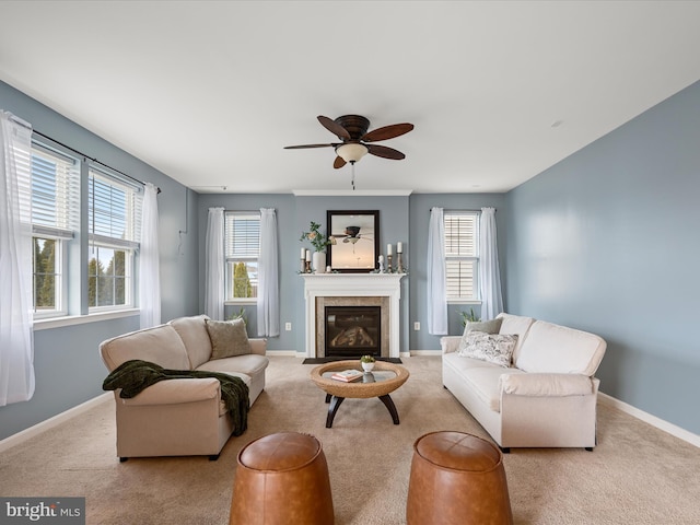 living room featuring light carpet, ceiling fan, and a healthy amount of sunlight