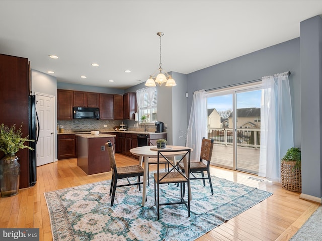 dining area featuring sink and light hardwood / wood-style flooring