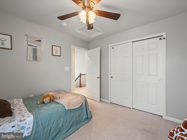 bedroom with light colored carpet, a closet, and ceiling fan