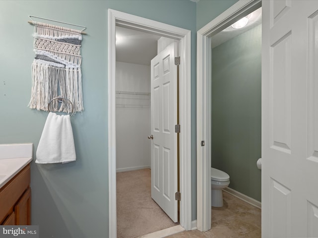 bathroom featuring vanity and toilet