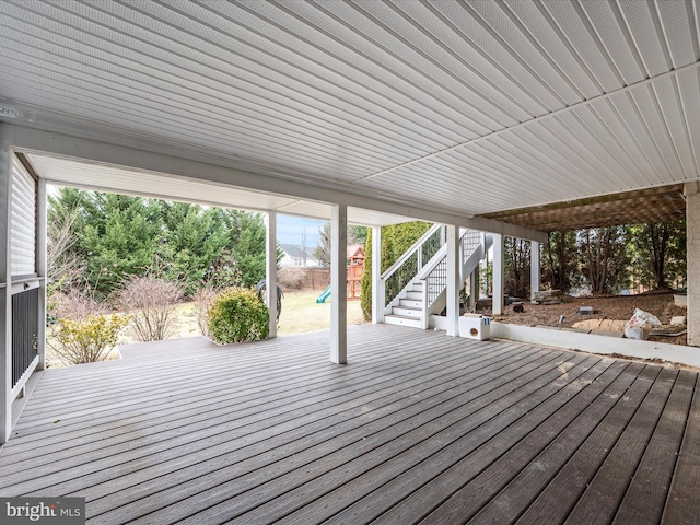 wooden terrace with a playground