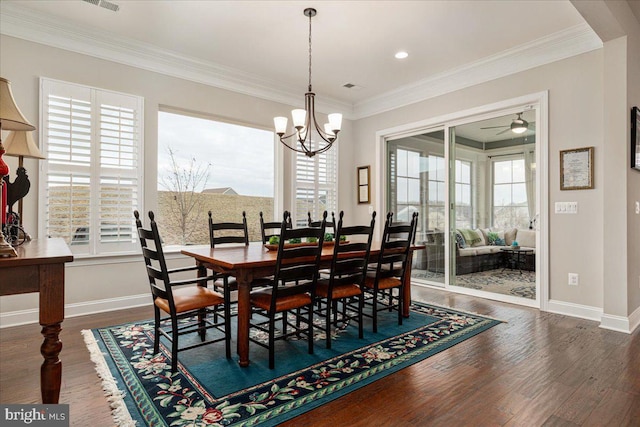 dining room with dark wood-type flooring, plenty of natural light, and baseboards