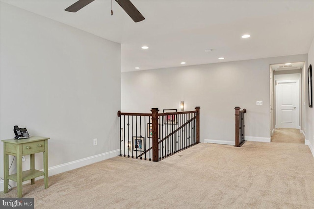 unfurnished room with recessed lighting, light colored carpet, and baseboards