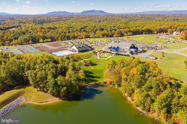 aerial view with a wooded view and a water and mountain view