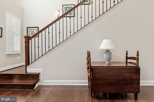 stairway with baseboards and wood finished floors