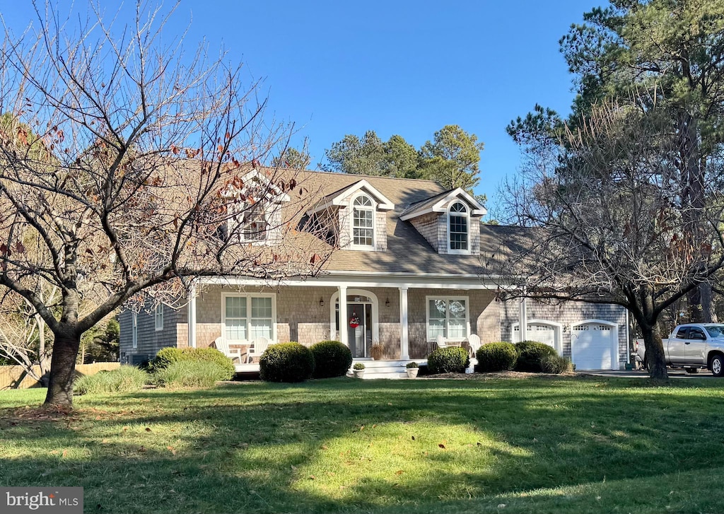 new england style home with a garage and a front yard