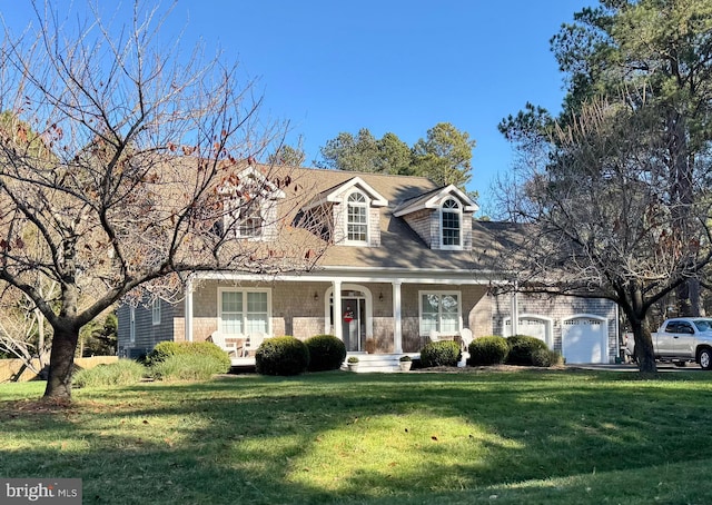 cape cod-style house featuring a garage, a front lawn, and a porch