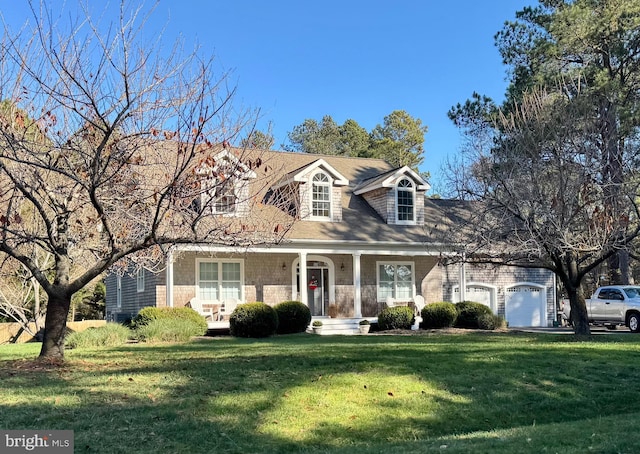 new england style home featuring a garage and a front lawn