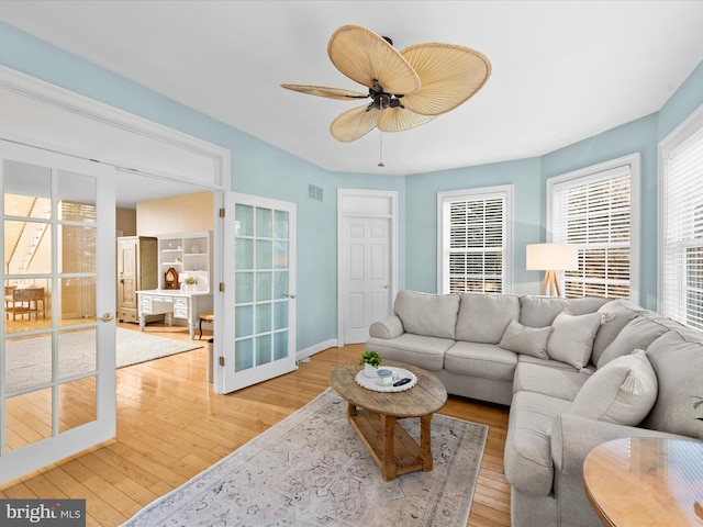 living room featuring hardwood / wood-style flooring, french doors, and ceiling fan