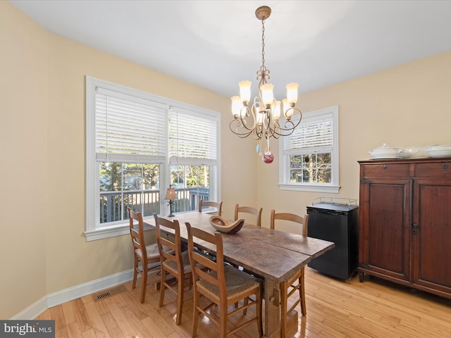 dining area featuring an inviting chandelier and light wood-type flooring