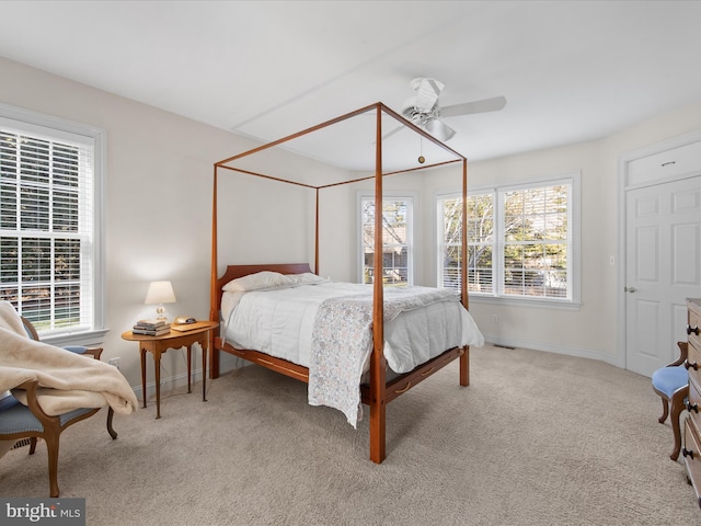 bedroom with ceiling fan and light colored carpet