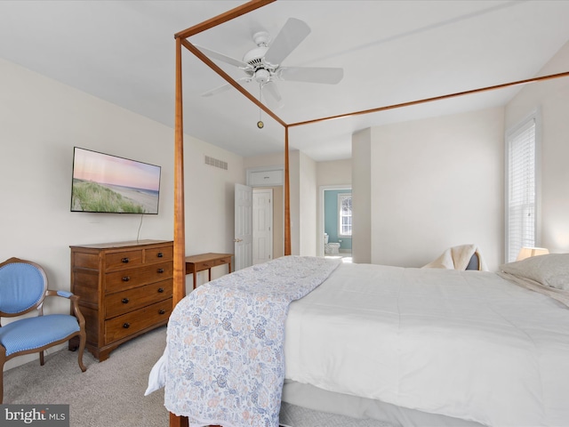 bedroom with light carpet, multiple windows, and ceiling fan