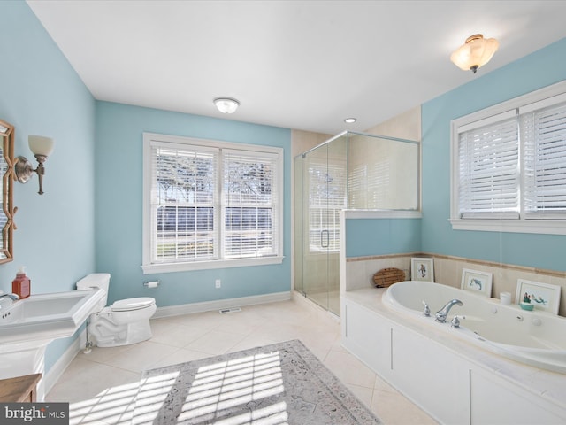 bathroom with tile patterned floors, toilet, and shower with separate bathtub