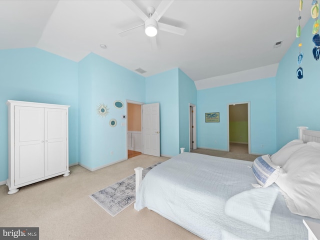 carpeted bedroom with vaulted ceiling and ceiling fan