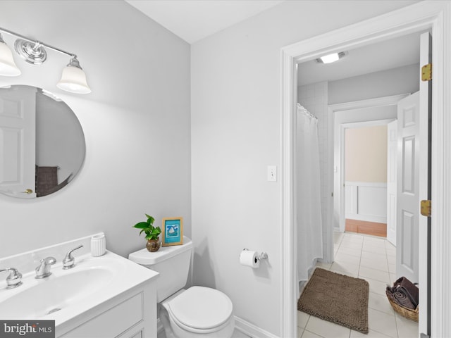 bathroom featuring vanity, tile patterned flooring, and toilet