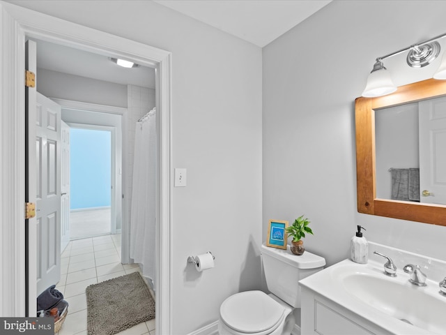 bathroom featuring tile patterned floors, vanity, and toilet