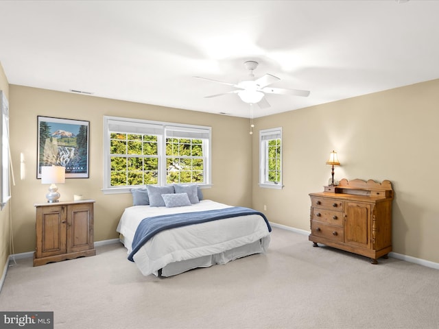 bedroom with light carpet and ceiling fan