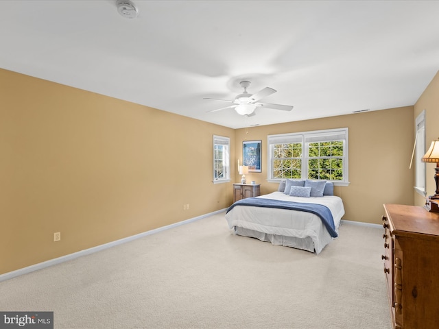 bedroom with light colored carpet and ceiling fan