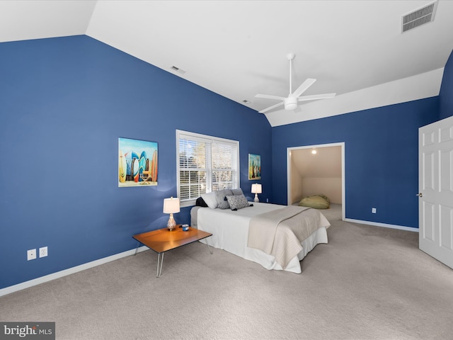 bedroom featuring vaulted ceiling, light colored carpet, and ceiling fan