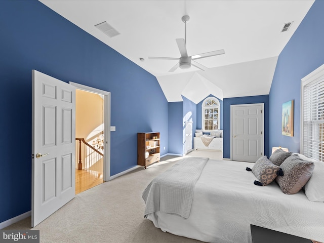 bedroom featuring light carpet, lofted ceiling, and ceiling fan