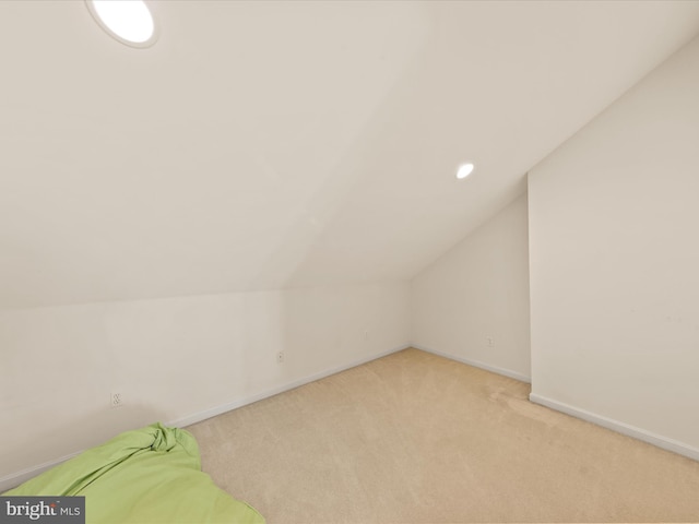 bonus room featuring light carpet and vaulted ceiling