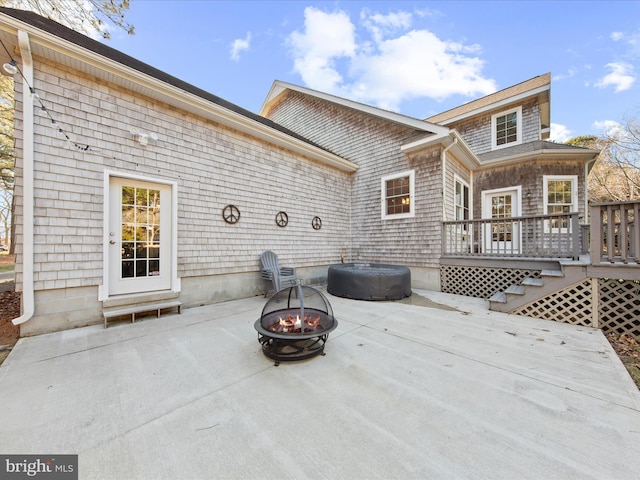 view of patio / terrace featuring a wooden deck and an outdoor fire pit