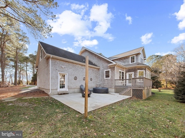 rear view of property with a wooden deck, a yard, and a patio