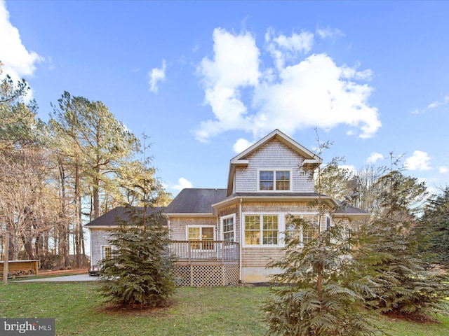 view of front of home with a front yard and a deck