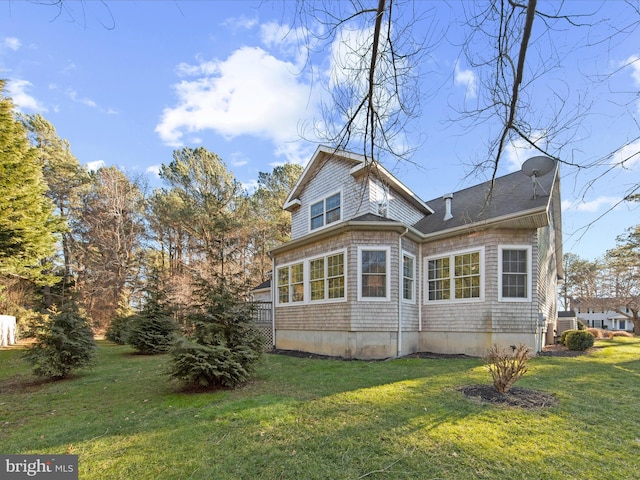 rear view of property with a lawn