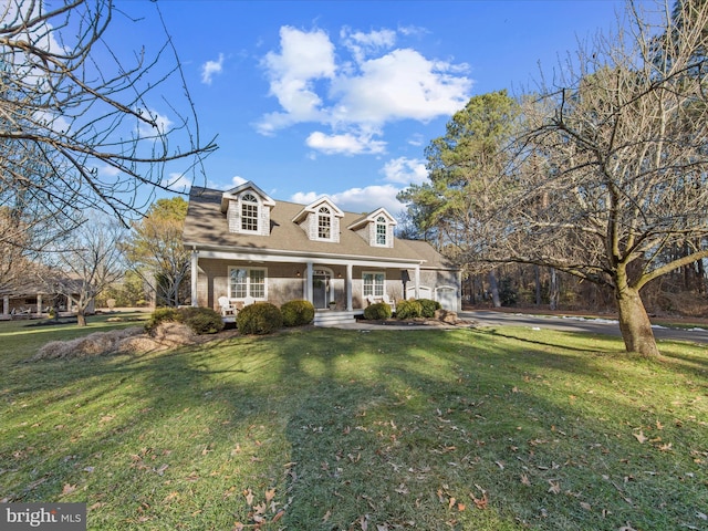 cape cod house with covered porch and a front lawn