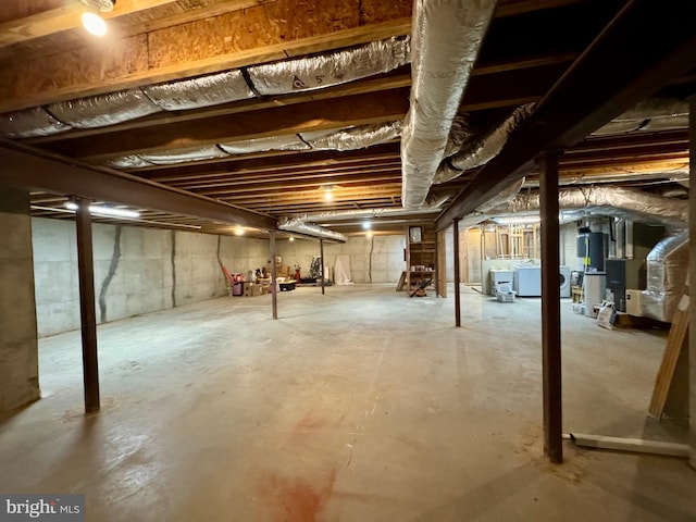 unfinished basement featuring heating unit and washing machine and clothes dryer