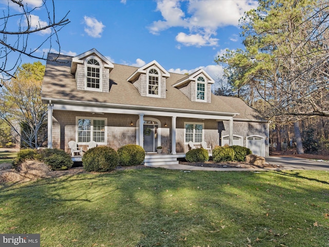 cape cod-style house with a garage, a front lawn, and covered porch