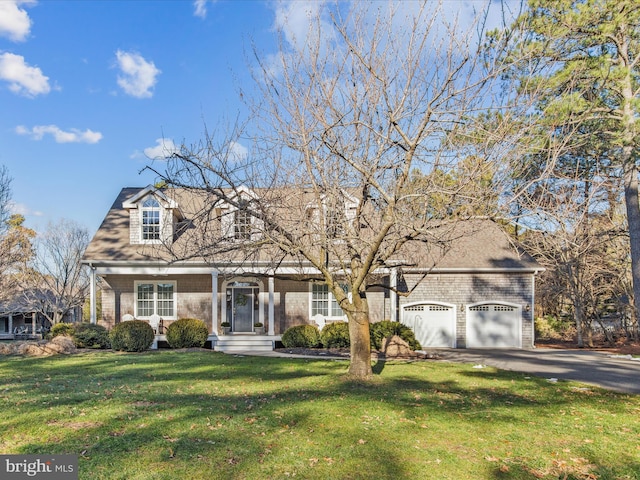 cape cod house featuring a garage and a front yard