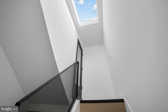 staircase with hardwood / wood-style flooring