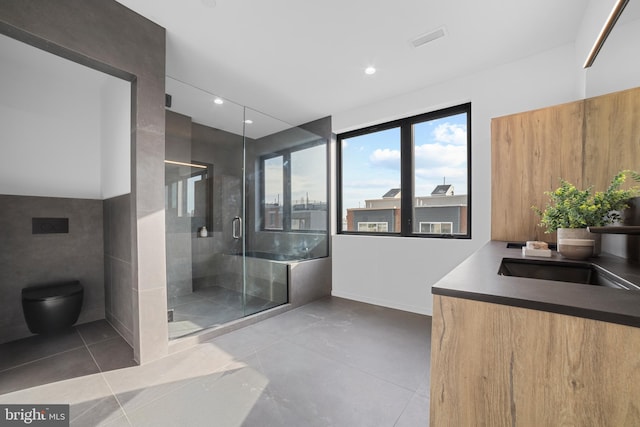 bathroom featuring a shower with door, vanity, tile patterned floors, and toilet