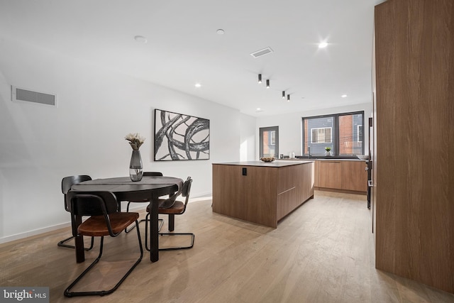 dining area with light wood-type flooring