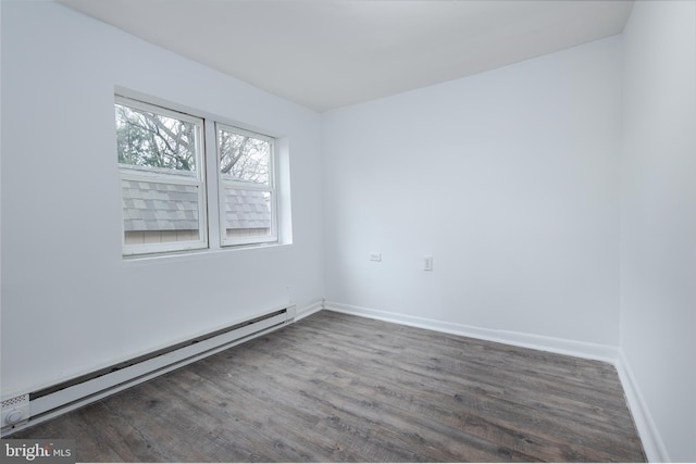 unfurnished room with baseboard heating and hardwood / wood-style flooring