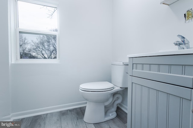 bathroom with vanity, hardwood / wood-style floors, and toilet