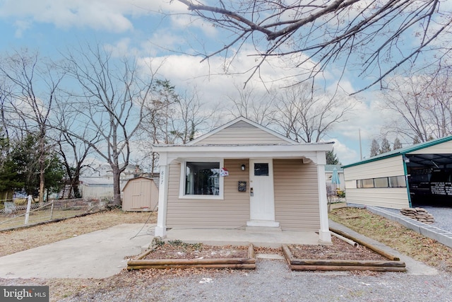 bungalow-style home with a storage unit