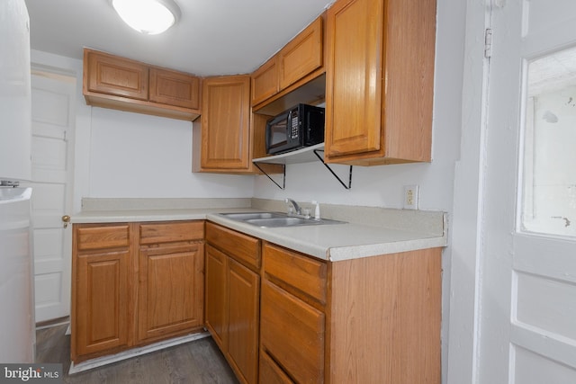 kitchen featuring dark hardwood / wood-style flooring and sink