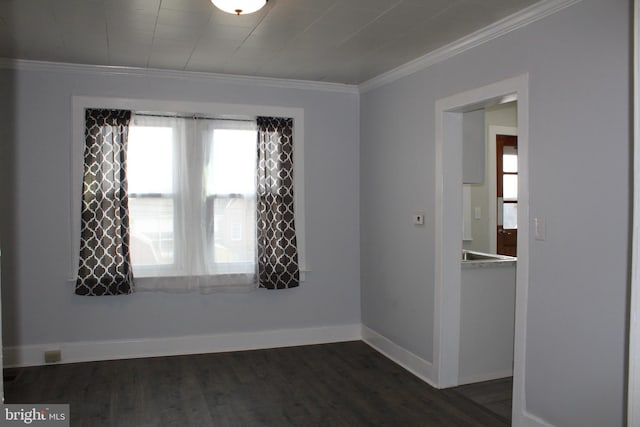 empty room with ornamental molding and dark hardwood / wood-style floors