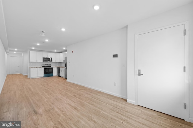 unfurnished living room featuring light wood-type flooring