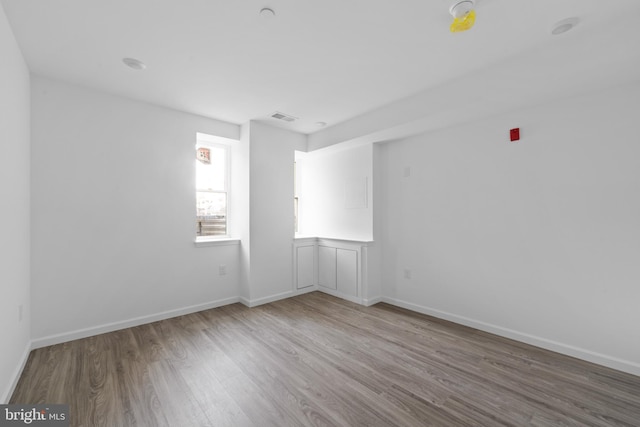 spare room featuring wood-type flooring