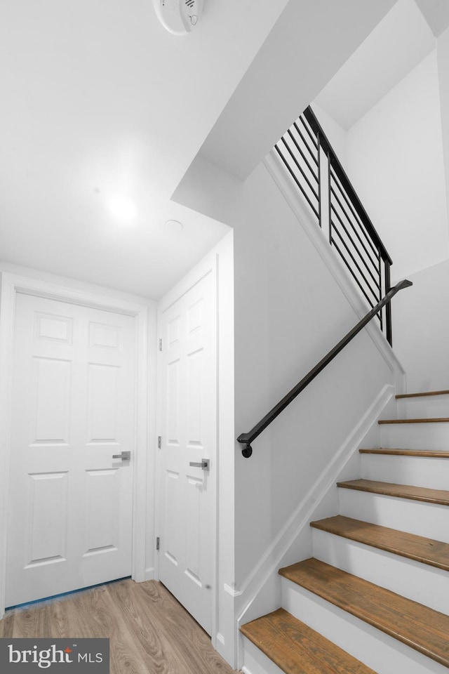 staircase featuring wood-type flooring