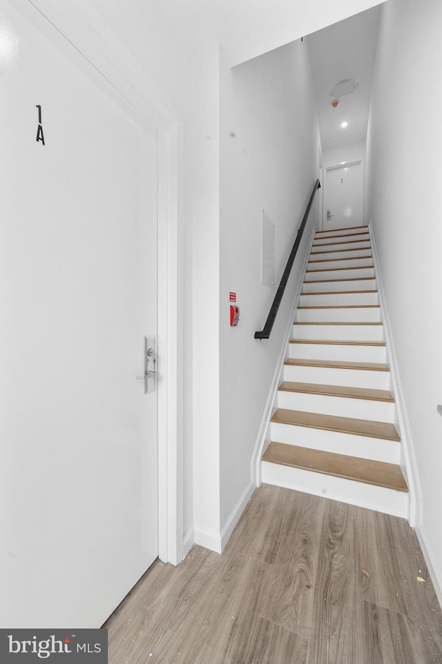 staircase featuring hardwood / wood-style floors