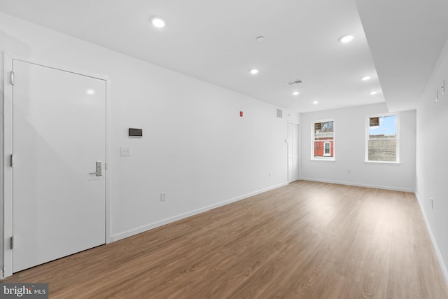 spare room with light hardwood / wood-style flooring